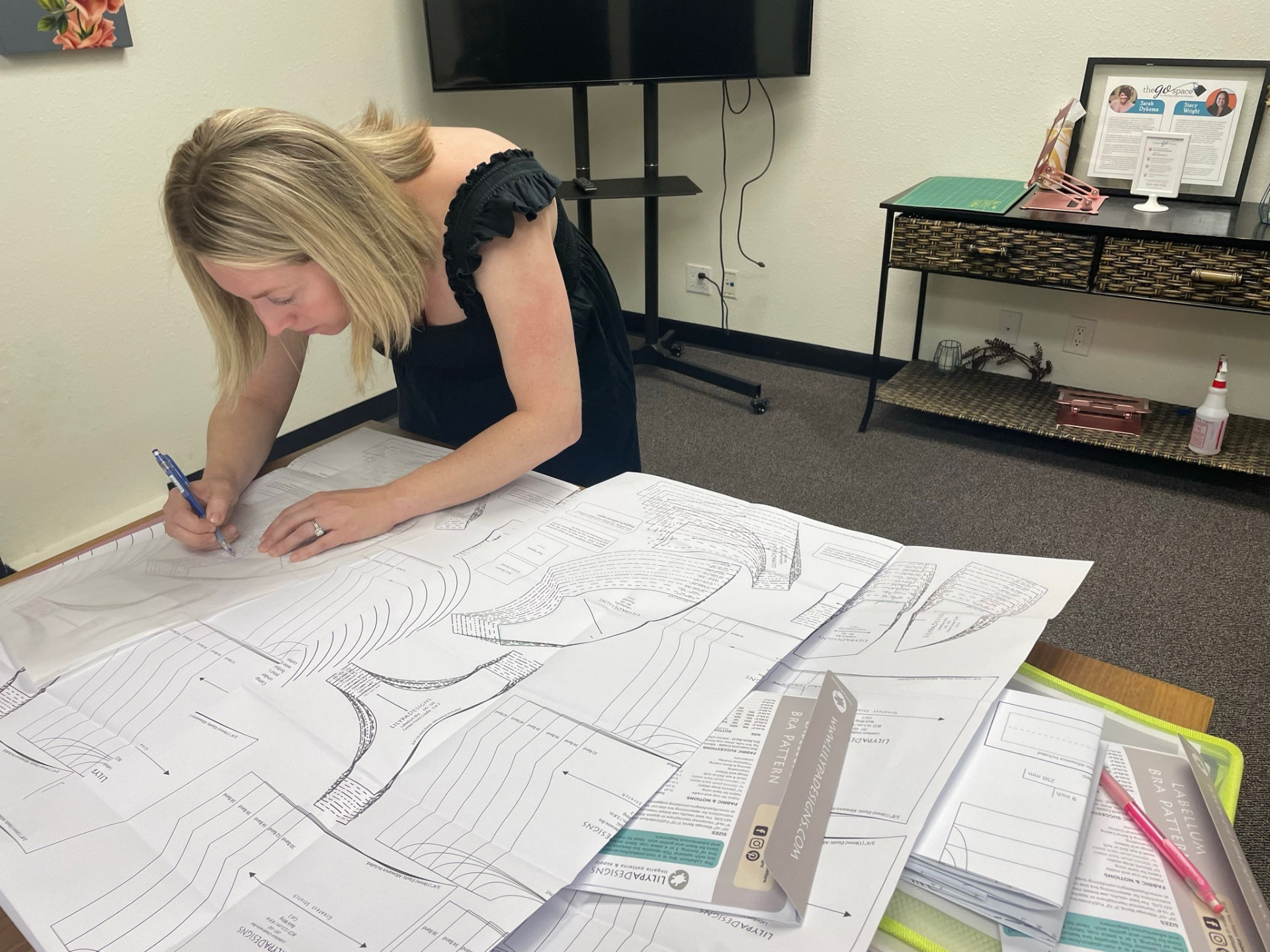 Allison drafting bra patterns at the table