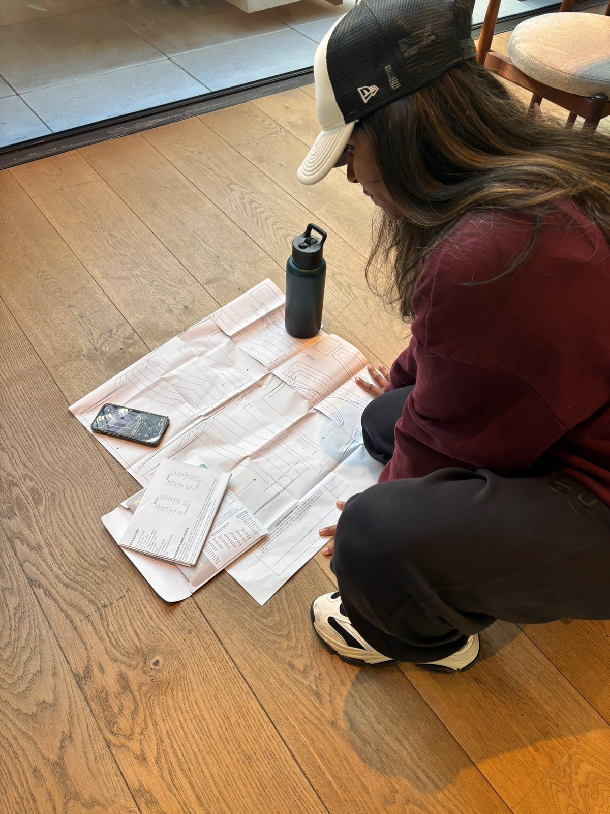 Patricia working through bra patterns on the floor